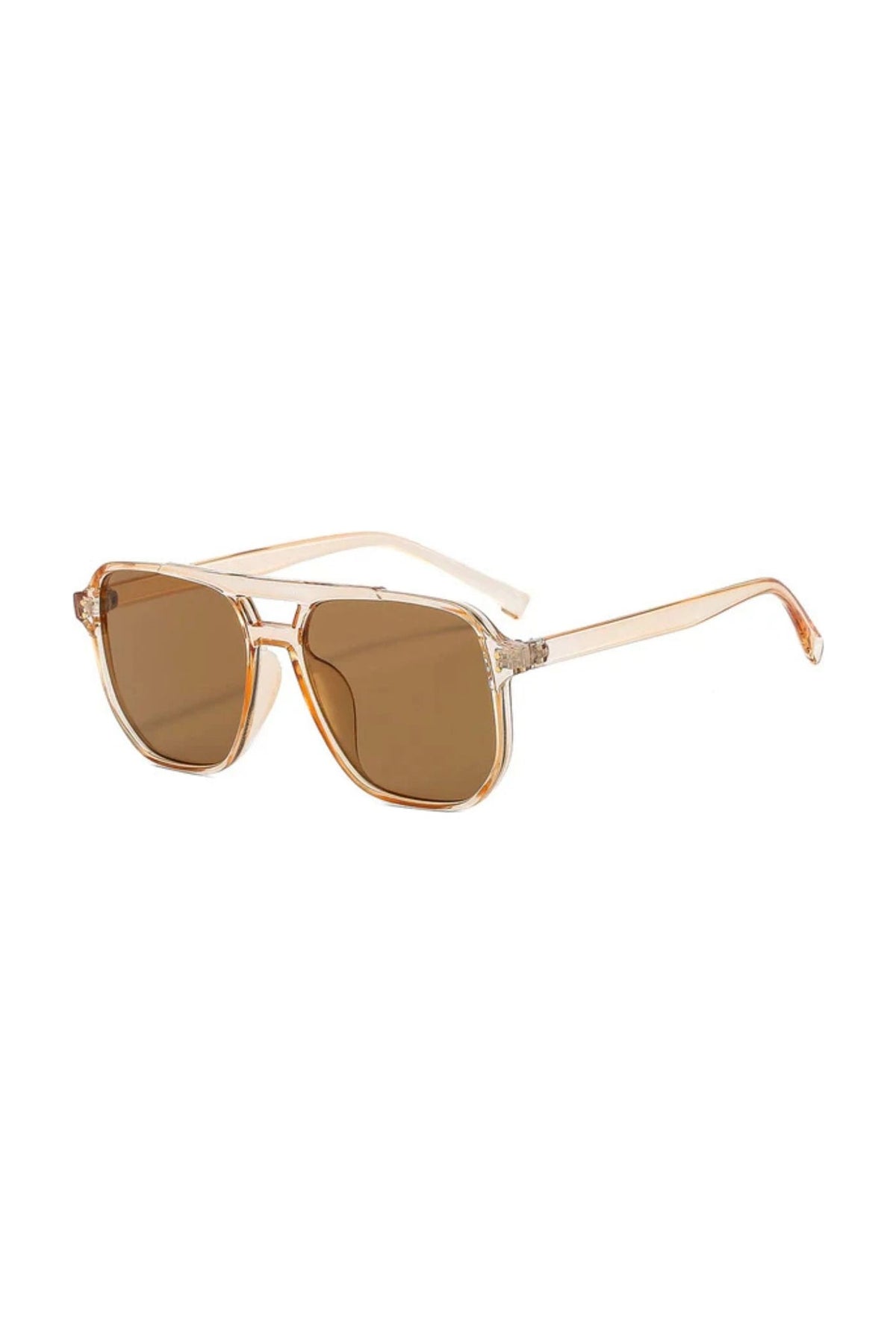 The NUDE sunglasses by SIMI Eyewear feature beige, transparent frames and brown-tinted lenses, shown at a three-quarter angle against a white background.