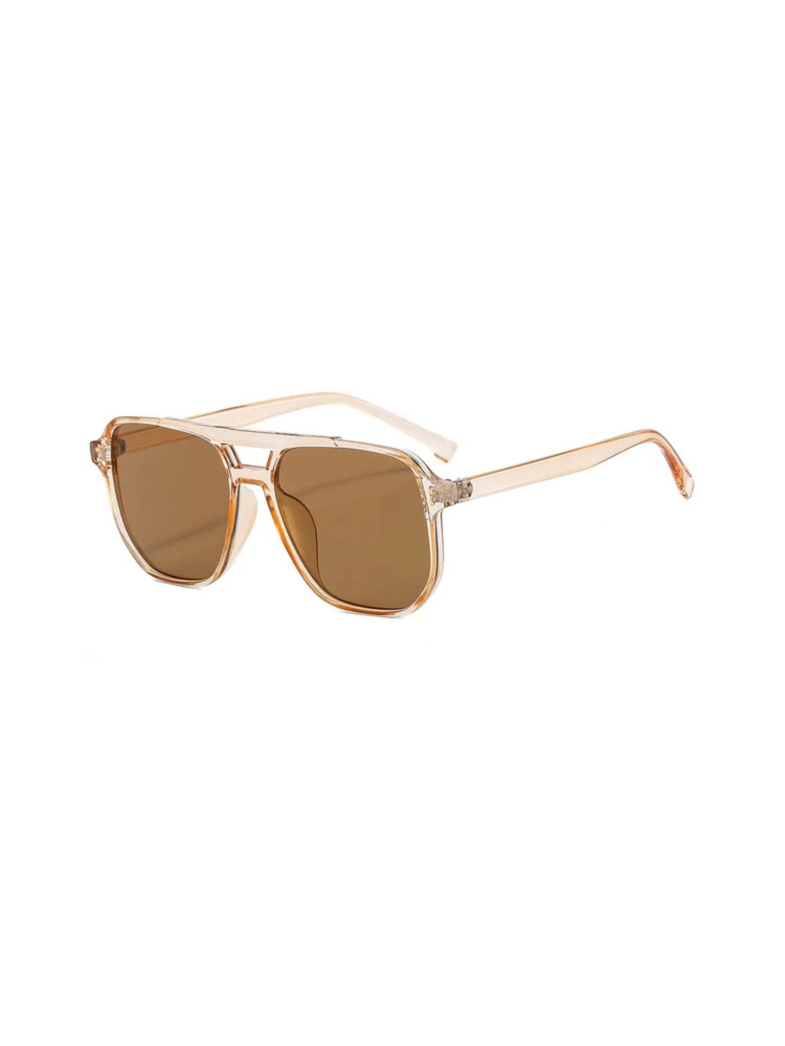 The NUDE sunglasses by SIMI Eyewear feature beige, transparent frames and brown-tinted lenses, shown at a three-quarter angle against a white background.