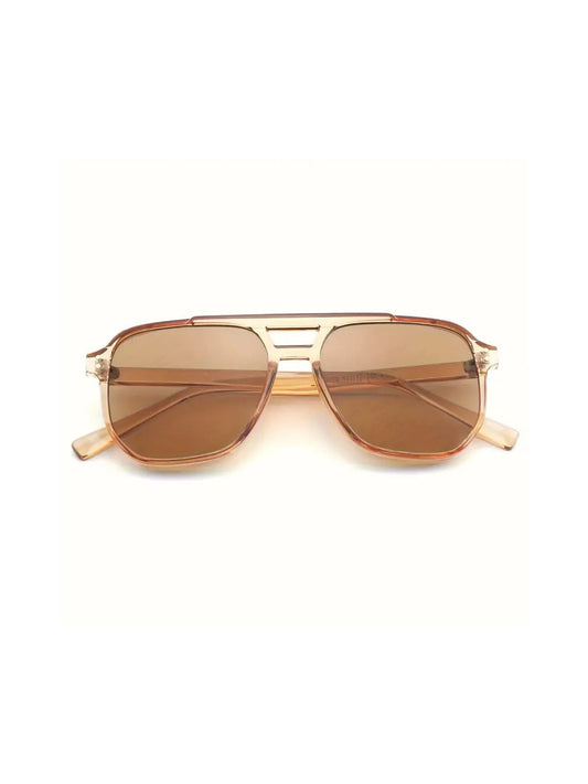 The NUDE sunglasses by SIMI Eyewear feature brown-tinted aviator lenses, a transparent frame, and a decorative double bridge, shown on a white background.